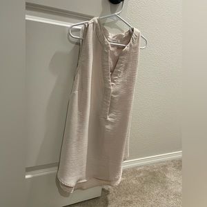 Tan sleeveless blouse. Loose fitting. Excellent condition. Size small.
